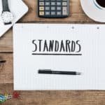 notepad with standards written on it. FCC closed captioning standards for online video