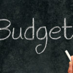 Budget, written with white chalk on a blackboard. Video Captioning Budget