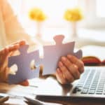 Woman is trying to connect couple puzzle pieces; Closed Captions vs. Subtitles