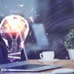 Best reasons to use video captions showcased through a lightbulb hologram on a computer.