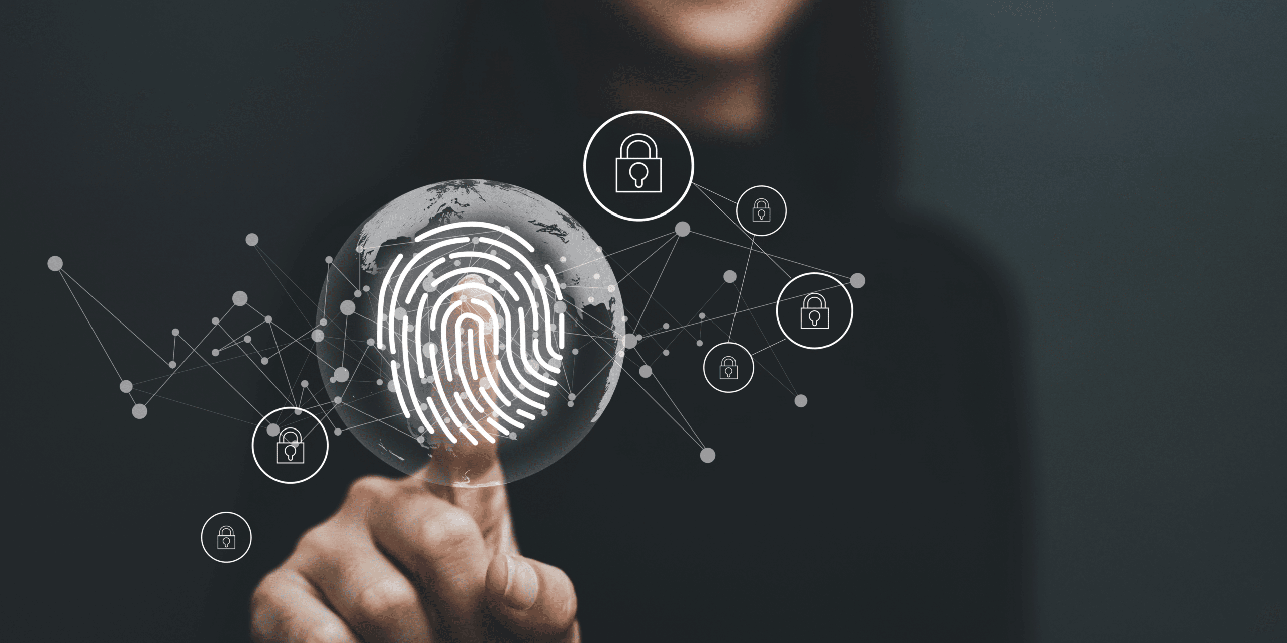 Person touching a glass screen with a fingerprint on it.